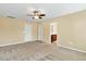 Spacious bedroom with two doors, neutral tones, and carpet flooring at 225 Gulley Glen Dr, Garner, NC 27529