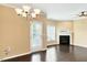 Dining area with hardwood floors, a chandelier, and a door leading to the exterior at 225 Gulley Glen Dr, Garner, NC 27529
