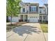 Charming townhome featuring a one-car garage and a well-maintained lawn and shrubbery at 225 Gulley Glen Dr, Garner, NC 27529