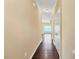 Hallway with hardwood flooring and neutral paint leading to a naturally lit living area at 225 Gulley Glen Dr, Garner, NC 27529
