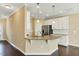Bright kitchen features granite countertops, white cabinets, stainless steel appliances, and hardwood floors at 225 Gulley Glen Dr, Garner, NC 27529