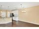 Open kitchen and dining area with white cabinets, granite countertops, and hardwood flooring at 225 Gulley Glen Dr, Garner, NC 27529