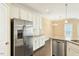 This kitchen features granite countertops, stainless appliances, white cabinets, tile backsplash, and hardwood floors at 225 Gulley Glen Dr, Garner, NC 27529