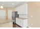 This kitchen features white cabinets, stainless steel appliances, granite countertops, and hardwood floors at 225 Gulley Glen Dr, Garner, NC 27529