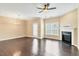 Spacious living room with hardwood floors, a fireplace, and a ceiling fan at 225 Gulley Glen Dr, Garner, NC 27529