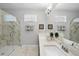 Bright bathroom featuring dual sinks, modern fixtures, and a glass-enclosed marble tiled shower at 2323 Big Sky Ln, Raleigh, NC 27615