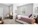 Cozy bedroom with natural light, featuring a comfortable bed, chair, and neutral decor for a relaxing space at 2323 Big Sky Ln, Raleigh, NC 27615