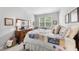 Charming bedroom with a large window, dresser with mirror, and a cozy quilt for a warm, inviting feel at 2323 Big Sky Ln, Raleigh, NC 27615