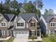 Charming two-story home with a combination of stone and siding, complemented by a well-manicured lawn at 2323 Big Sky Ln, Raleigh, NC 27615