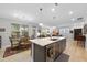 Bright open kitchen with a large island that offers seating and views of the dining and living area at 2323 Big Sky Ln, Raleigh, NC 27615