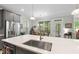 Spacious open kitchen with stainless steel appliances, a large island, and an adjacent dining area with natural light at 2323 Big Sky Ln, Raleigh, NC 27615