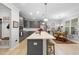 Open kitchen featuring an island with seating, stainless appliances, and an adjacent dining area with lots of natural light at 2323 Big Sky Ln, Raleigh, NC 27615