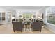 Spacious living room featuring bright windows, comfortable seating, and light hardwood flooring at 2323 Big Sky Ln, Raleigh, NC 27615