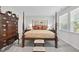 Traditional main bedroom with a four-poster bed, dark wood furniture, and neutral tones at 2323 Big Sky Ln, Raleigh, NC 27615