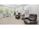 Office space with two leather chairs, a glass-top table, a desk, and multiple windows for lots of natural light at 2323 Big Sky Ln, Raleigh, NC 27615