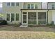 Exterior back view showcasing a screened porch and backyard area at 2323 Big Sky Ln, Raleigh, NC 27615