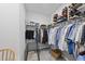 Walk-in closet with ample storage, multiple shelves, and hanging rods for organized clothing and shoes at 2323 Big Sky Ln, Raleigh, NC 27615