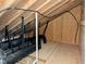 Unfinished attic space with exposed rafters and beams, featuring black plastic tubing at 2472 Patriot Bluffs Dr, Fuquay Varina, NC 27526