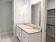 Bright bathroom featuring double vanity with granite counters and a large mirror at 2472 Patriot Bluffs Dr, Fuquay Varina, NC 27526