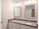 Bright bathroom features dual sinks with granite counters and updated light fixtures at 2472 Patriot Bluffs Dr, Fuquay Varina, NC 27526
