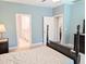 Comfortable primary bedroom features hardwood floors and ensuite bathroom at 2472 Patriot Bluffs Dr, Fuquay Varina, NC 27526