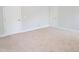 Empty bedroom with plush carpeting, multiple doors, and fresh white trim at 2472 Patriot Bluffs Dr, Fuquay Varina, NC 27526