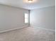 Neutral bedroom featuring plush carpet, window allowing natural light, and fresh neutral paint at 2472 Patriot Bluffs Dr, Fuquay Varina, NC 27526
