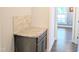 Granite countertop with neutral backsplash next to a hallway at 2472 Patriot Bluffs Dr, Fuquay Varina, NC 27526