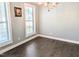 Dining room with dark hardwood floors, large windows, and modern lighting at 2472 Patriot Bluffs Dr, Fuquay Varina, NC 27526