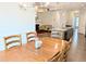 Cozy dining room adjacent to the living room and kitchen has a stylish wooden table and ample lighting at 2472 Patriot Bluffs Dr, Fuquay Varina, NC 27526