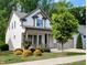 Charming two-story home with a welcoming front porch and landscaped yard at 2472 Patriot Bluffs Dr, Fuquay Varina, NC 27526