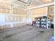 Spacious unfinished garage with concrete floor and storage shelves at 2472 Patriot Bluffs Dr, Fuquay Varina, NC 27526