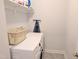 Laundry room equipped with stacked washer and dryer and overhead storage at 2472 Patriot Bluffs Dr, Fuquay Varina, NC 27526