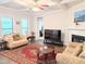 Bright living area features a fireplace, stylish furniture, and hardwood floors at 2472 Patriot Bluffs Dr, Fuquay Varina, NC 27526