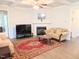 Comfortable living room features a fireplace, ceiling fan, and neutral tones at 2472 Patriot Bluffs Dr, Fuquay Varina, NC 27526