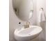 Bathroom featuring white sink with a framed mirror and stainless steel hardware at 253 Sweet Olive St, Clayton, NC 27527
