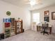 Bright bedroom with a ceiling fan, craft storage and a sewing machine at 253 Sweet Olive St, Clayton, NC 27527