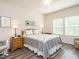 Cozy bedroom features hardwood floors, natural light, ceiling fan, neutral colors, and decor at 253 Sweet Olive St, Clayton, NC 27527