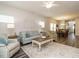 Bright living room flowing into the dining room showcasing hardwood floors and a ceiling fan at 253 Sweet Olive St, Clayton, NC 27527
