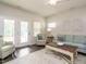 Living room with white walls, wood floors, decor, light blue couch and natural light at 253 Sweet Olive St, Clayton, NC 27527