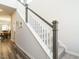 Bright staircase with white railings, gray trim, and carpeted steps leading to the upper level of the home at 253 Sweet Olive St, Clayton, NC 27527