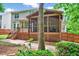 View of the deck and screened porch of this home with mature landscaping at 2639 Oleander Dr, Durham, NC 27703
