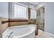 This bathroom features a tub, separate glass shower, and a tiled accent wall at 2639 Oleander Dr, Durham, NC 27703