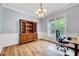 Bright dining room with hardwood floors, crown molding, and a classic chandelier at 2639 Oleander Dr, Durham, NC 27703