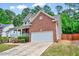 Side view of a two-story brick house, showcasing the attached garage and landscaping at 2639 Oleander Dr, Durham, NC 27703