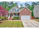 Charming brick two-story home with a covered front porch and well-manicured lawn at 2639 Oleander Dr, Durham, NC 27703