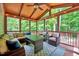 Relaxing screened porch with vaulted wood ceiling, ceiling fan, and wicker furniture at 2639 Oleander Dr, Durham, NC 27703