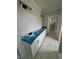Bathroom with white cabinets, granite countertop, tile flooring, and modern lighting at 27 Batten Hill Ln, Selma, NC 27576
