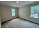 Bedroom with carpeted floors and two large windows at 27 Batten Hill Ln, Selma, NC 27576
