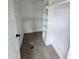 Walk-in closet with shelves and carpet at 27 Batten Hill Ln, Selma, NC 27576